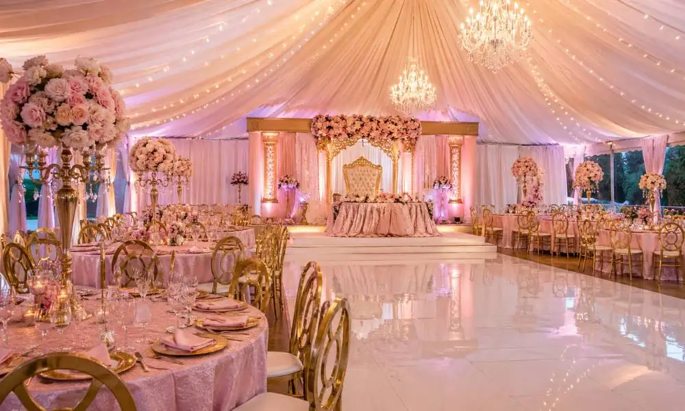 Close-up of quinceanera decoration packages featuring silk tablecloths and gold-rimmed event rentals.